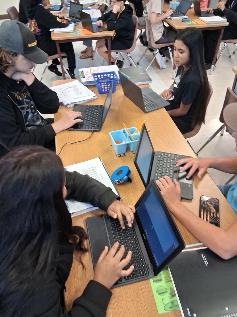 students in science class working on a project on their computers