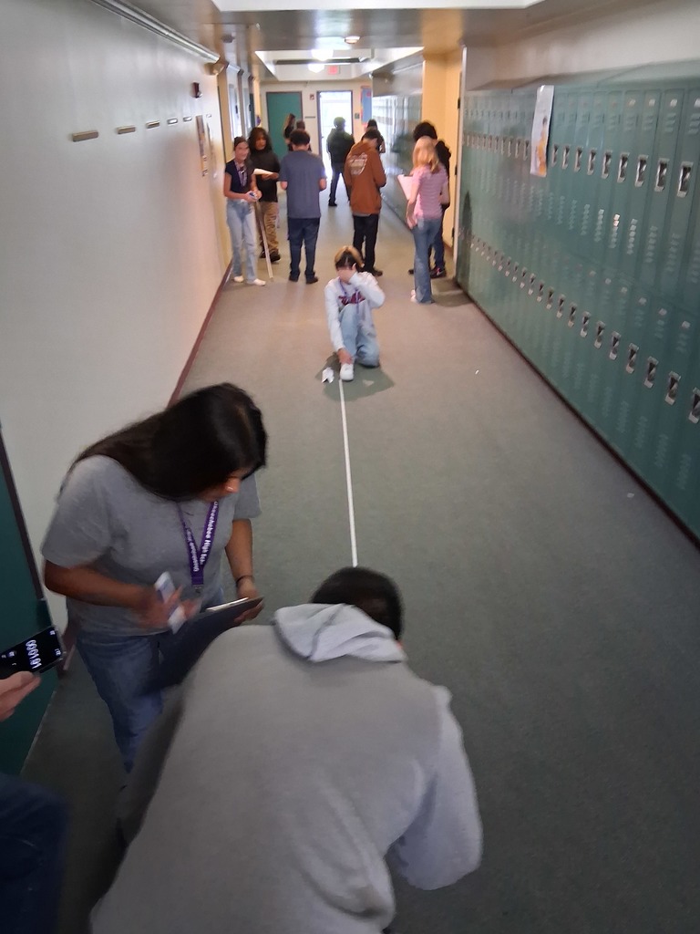 students holding string in hallway during experiment