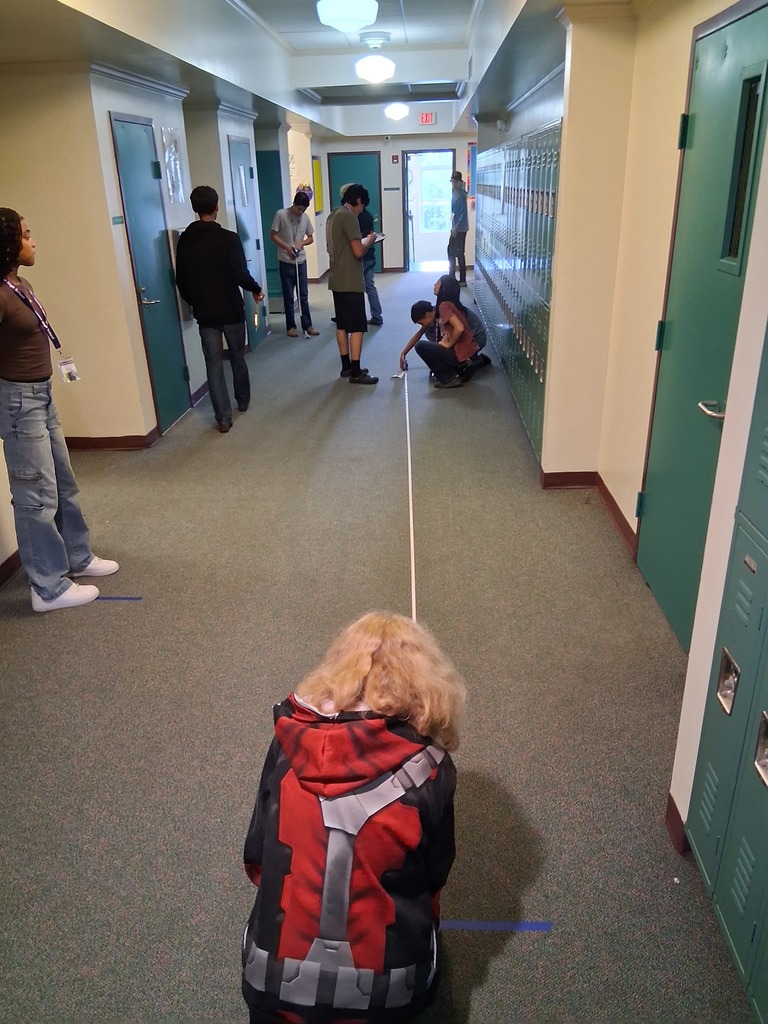 students holding string in hallway during experiment