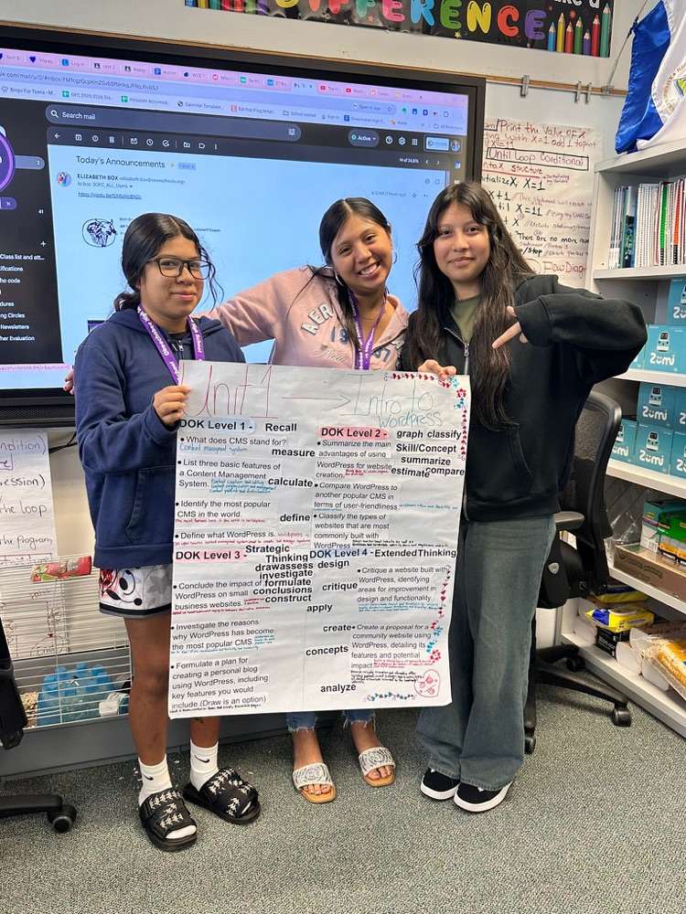 three students holding up dok poster