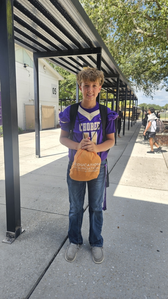 a student wearing football jersey in courtyard