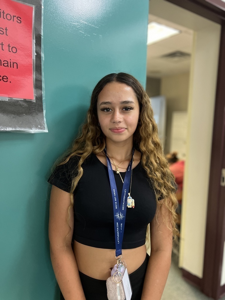female student standing by main office door