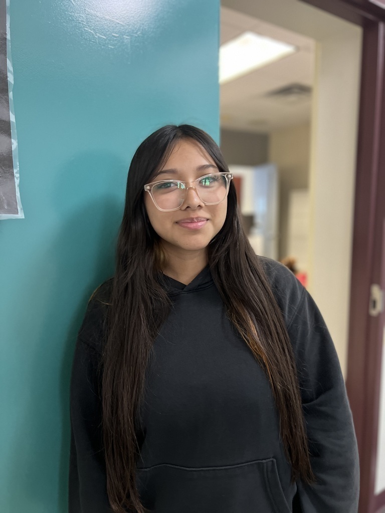 female student standing by main office door