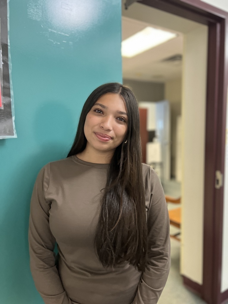 female student standing by main office door