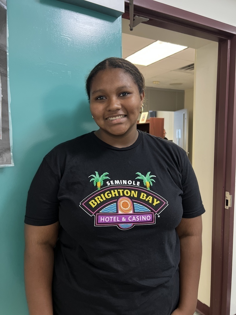 female student standing by main office door