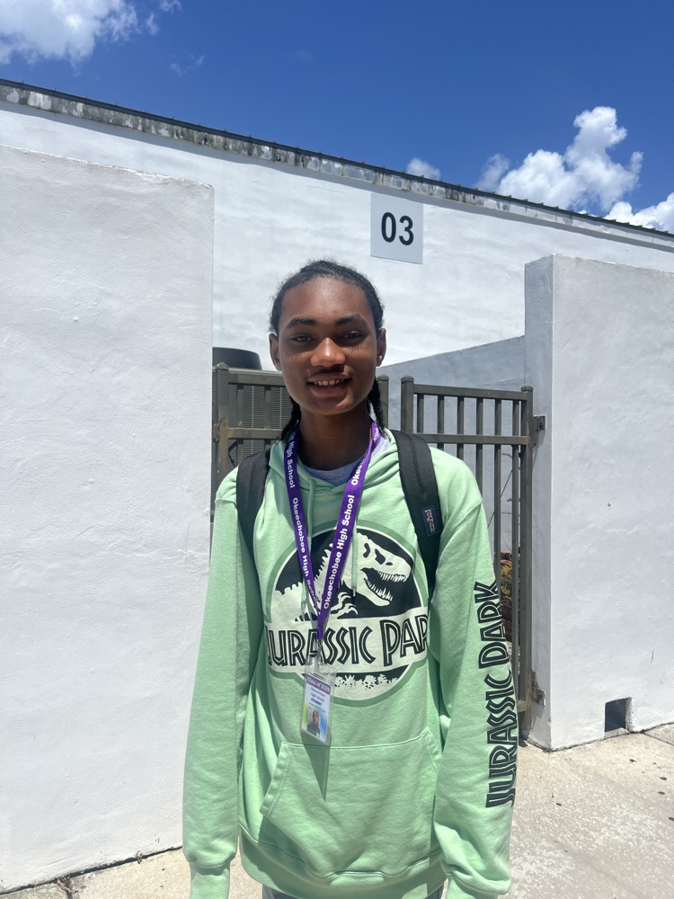 student standing outside school courtyard 