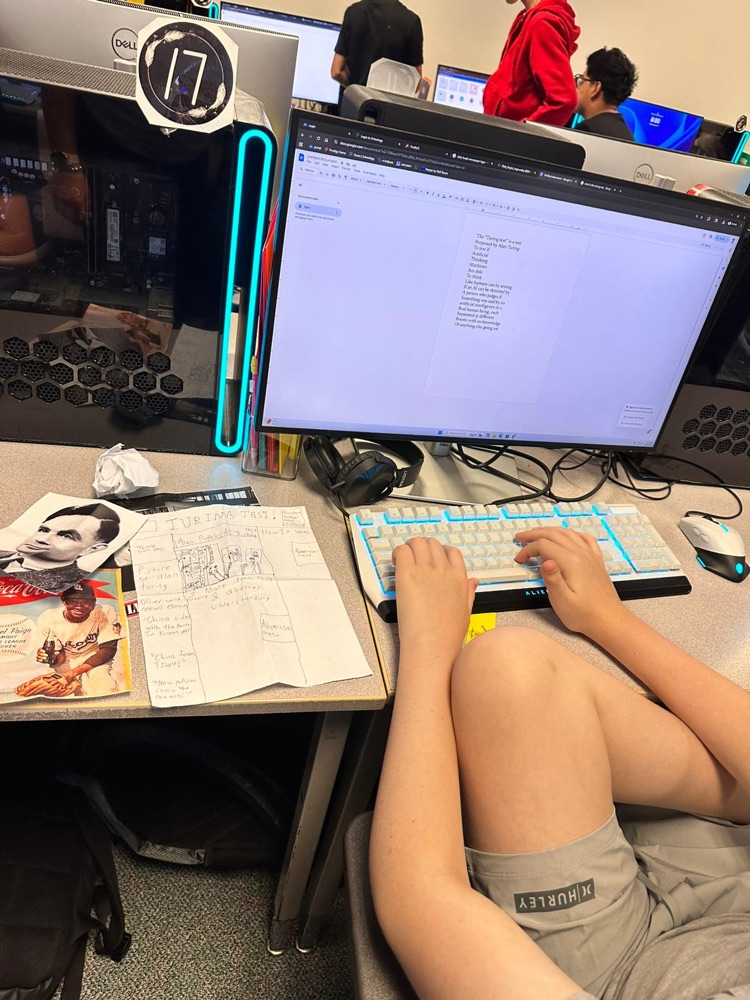 student typing into computer 