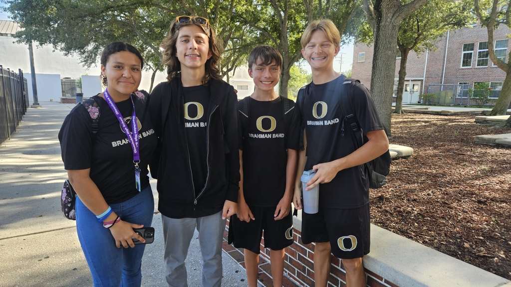 four students from band in the courtyard