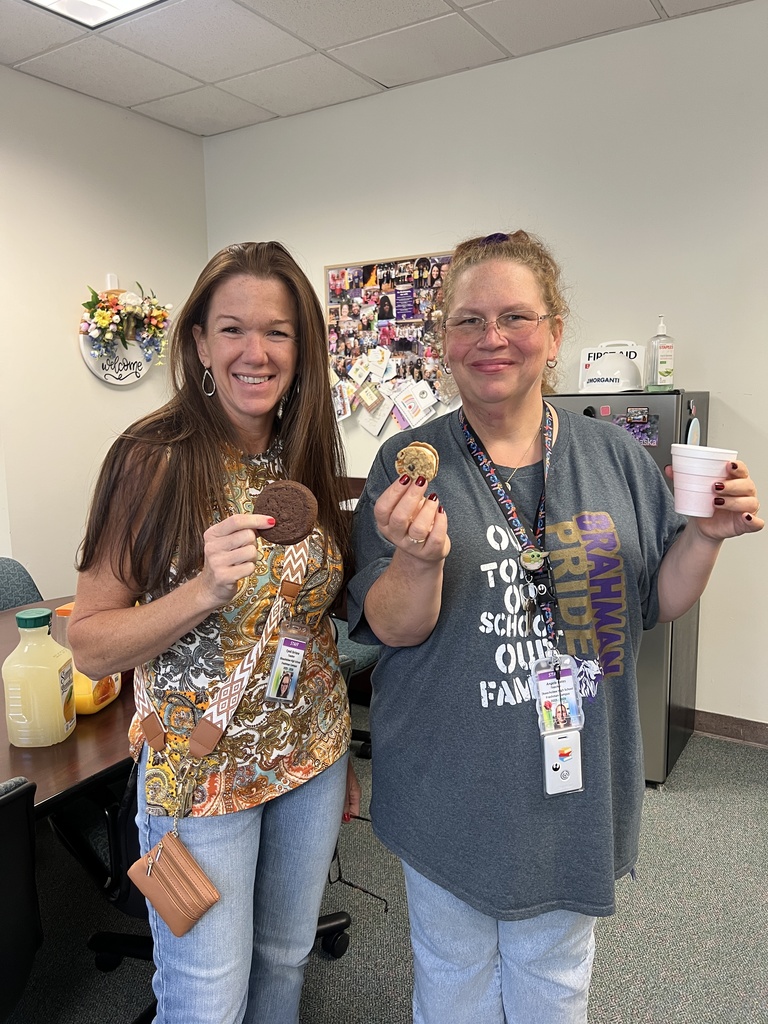 two teachers with cookies in the main office