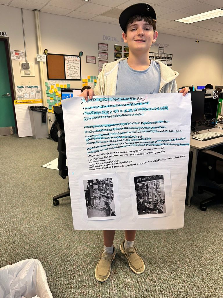student showing his poster for AI class
