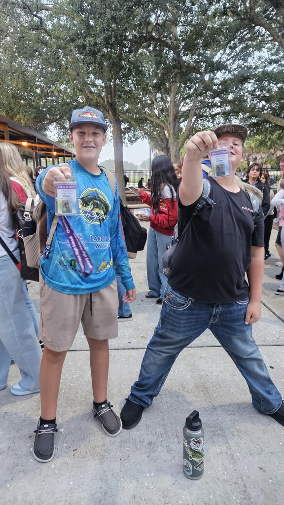 students showing school ID in courtyard