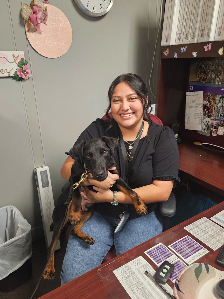 secretary holding k9 dog