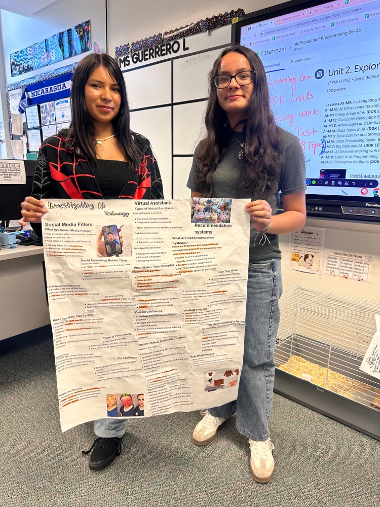 two female students infront of school posters they made