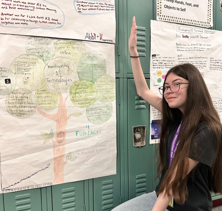 student showing poster hung on locker 
