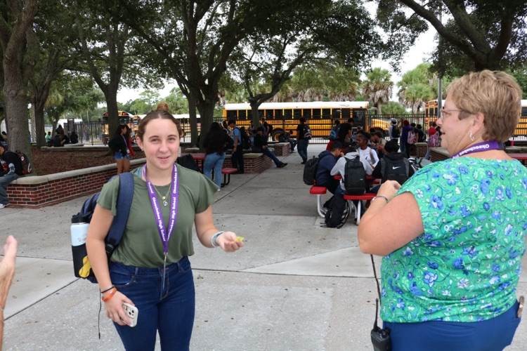student and principal in the school courtyard