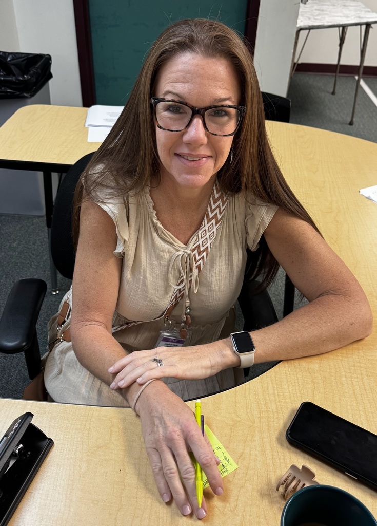 teacher looking up sitting down in desk