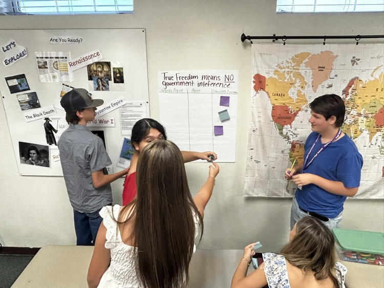 five students working on poster for celebrate freedom week