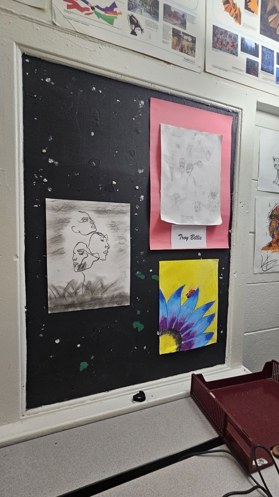 three art pieces hung in art class