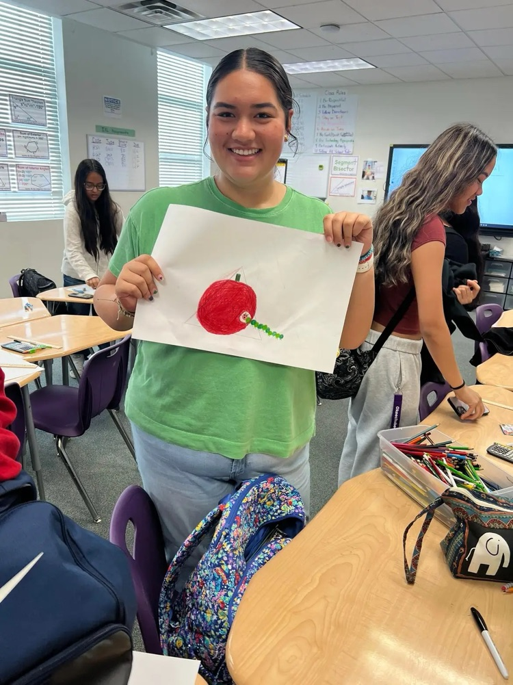student showing off geometry art project