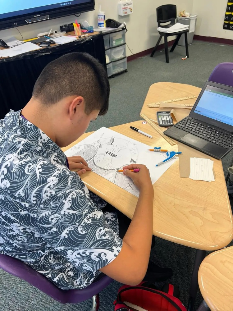 student drawing on paper in geometry class