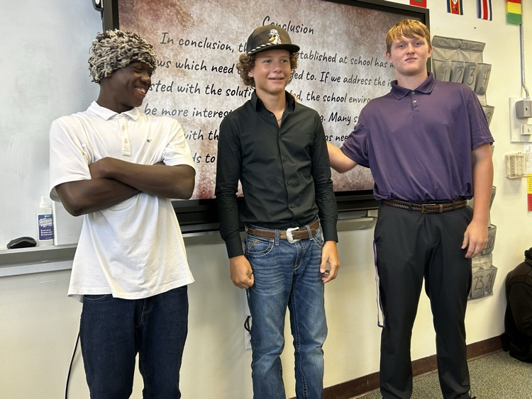 three students presenting a slideshow for celebrate freedom week