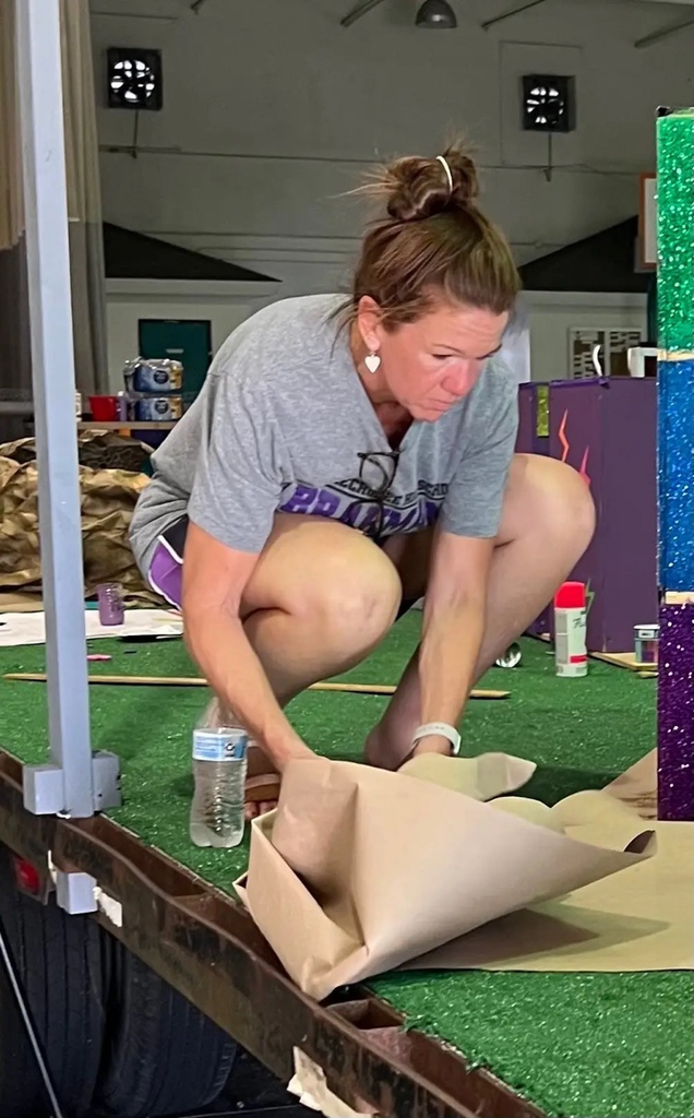 teacher working on homecoming float building 