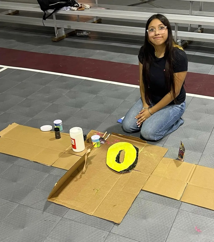 student working on accessories for homecoming float