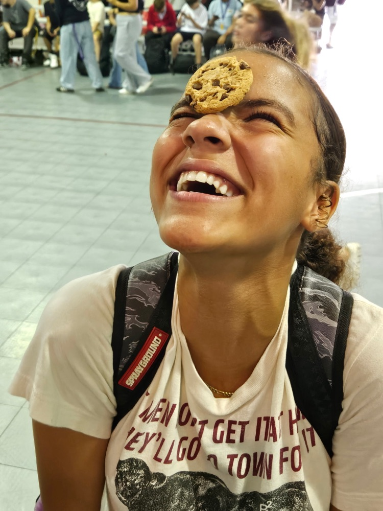 girl laughing with cookie on her face