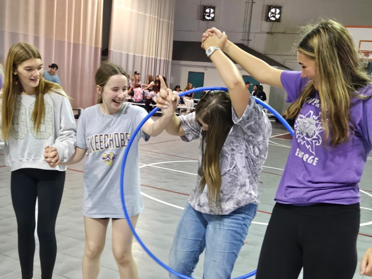 four girls playing homecoming game in gym