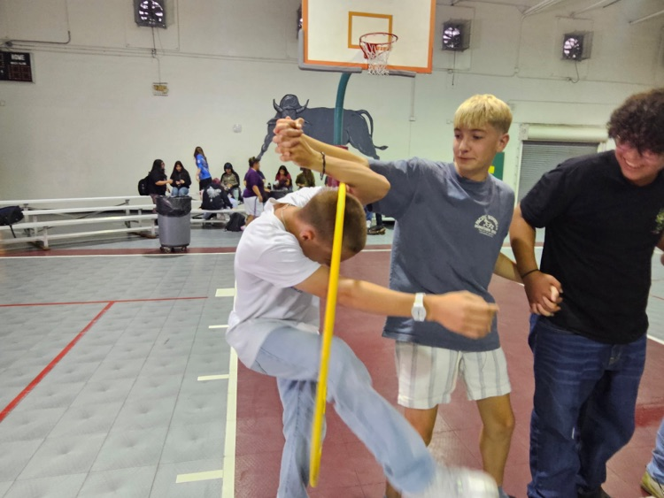 boys playing hula hoop game in gym