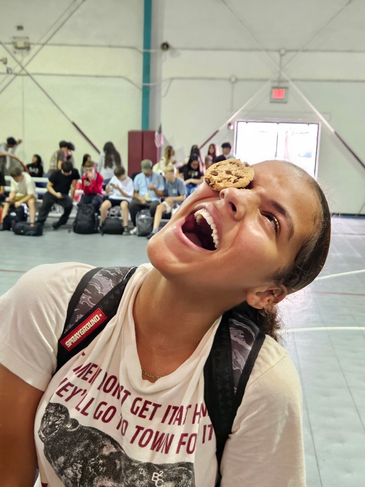 girl laughing with cookie on face