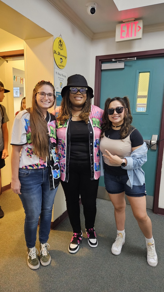 assistant principal and two teachers dressed for spirit week In hallway
