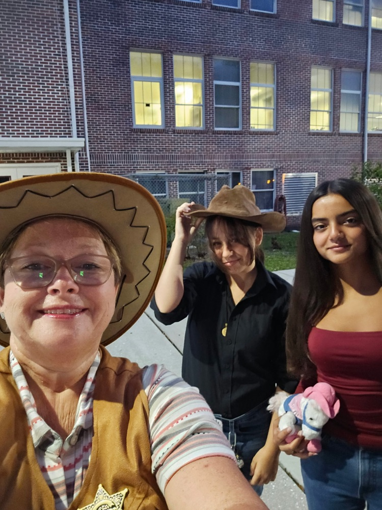 principal and two students dressed as Wild West 