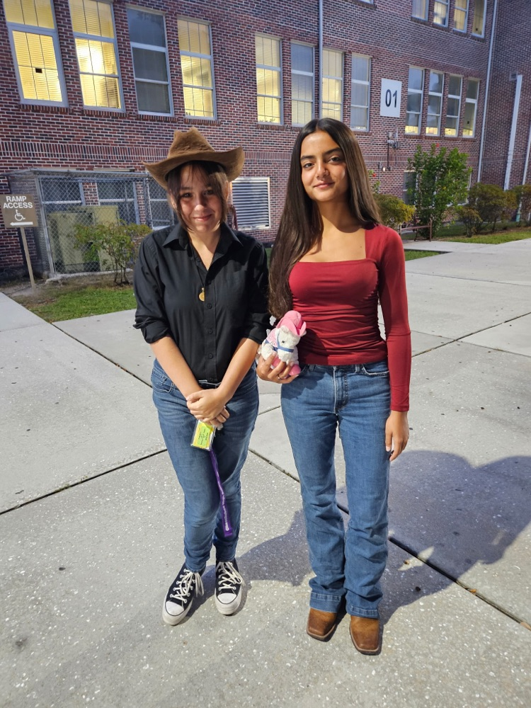 two students dressed for Wild West in courtyard