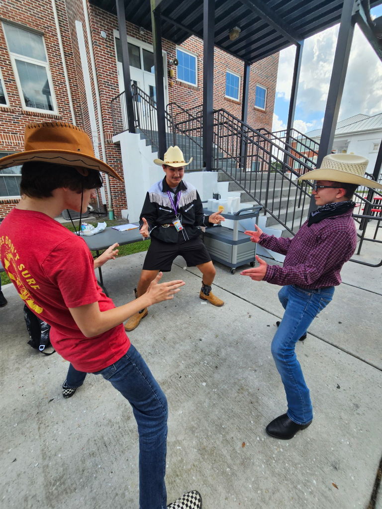 three boys pretending to be cowboys at school courtyard