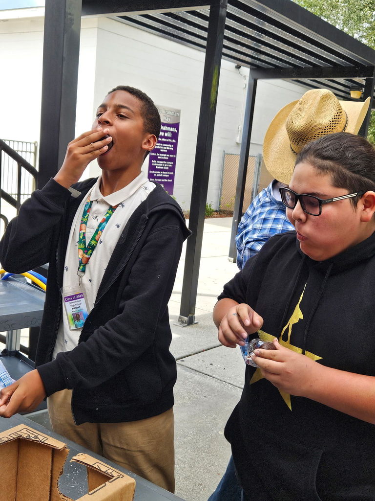 two boys eating doughnuts out at lunch