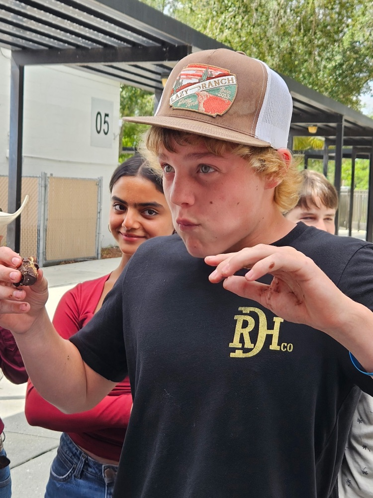 student stuffing his mouth with doughnuts at lunch