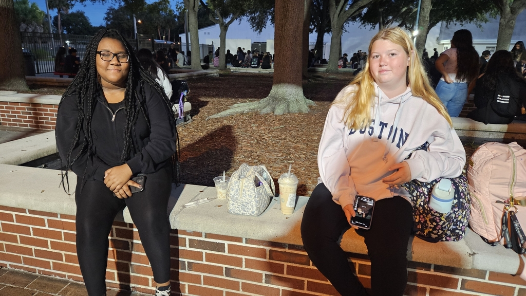 two girls sitting in courtyard early in the morning