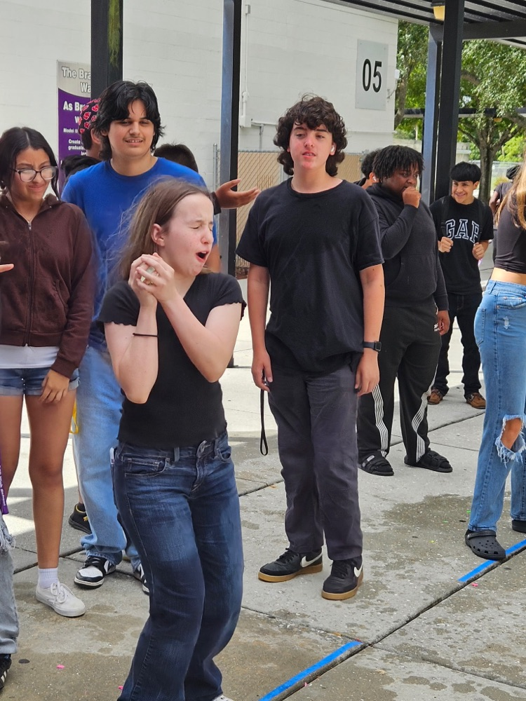 students playing water balloon games outside 