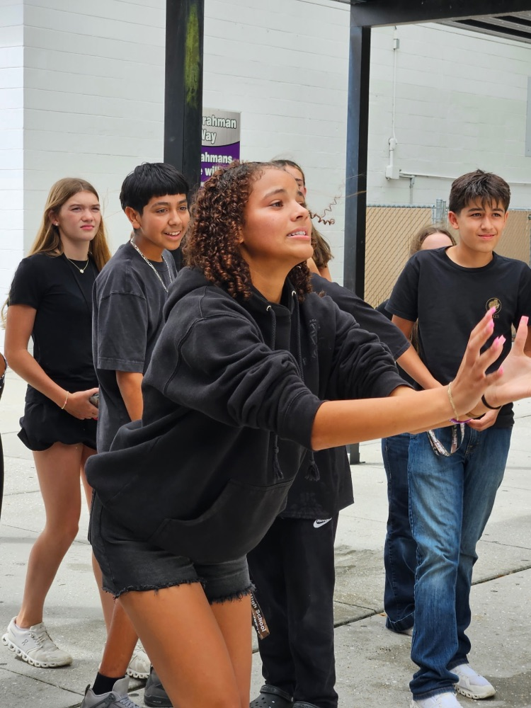 students playing water balloon game outside 