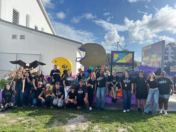 homecoming float with all the kids infront of it 