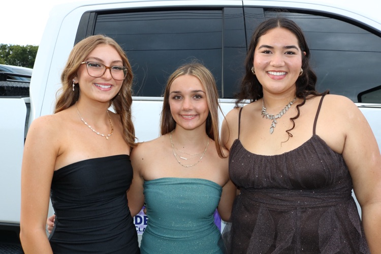 three homecoming court girls waiting for parade