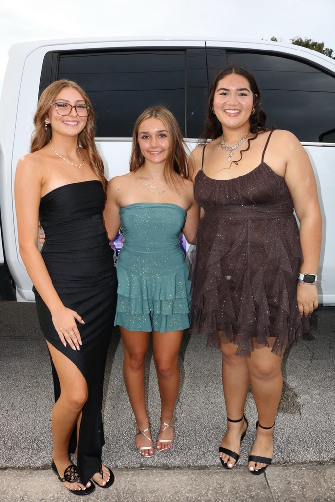 three homecoming court girls dressed for parade