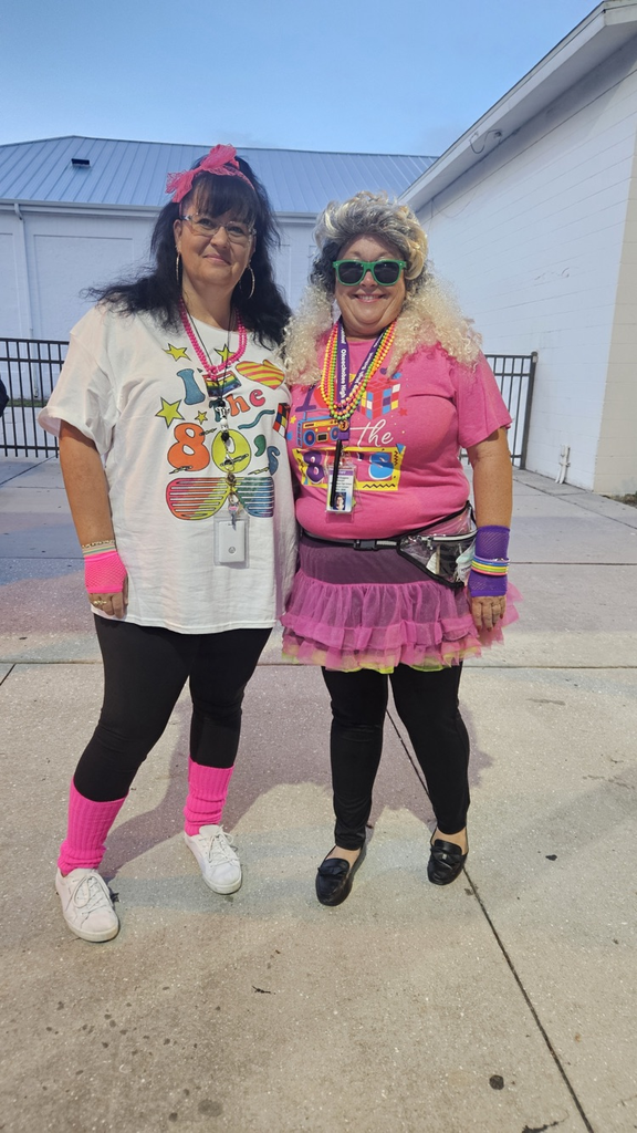nurse and principal dressed for the 80’s homecoming week