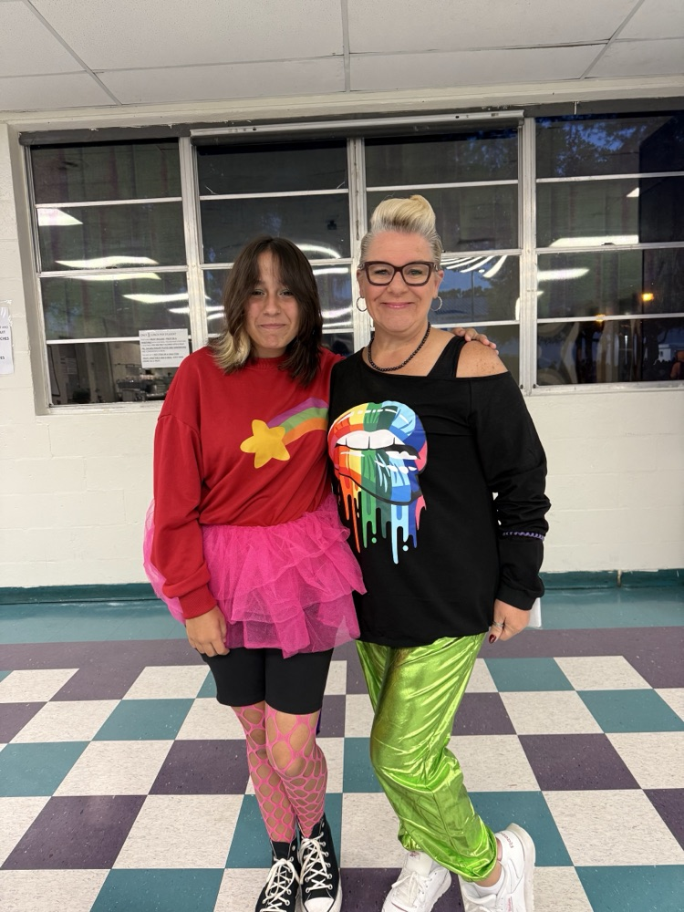 teacher and student dressed for the 80s in school cafeteria