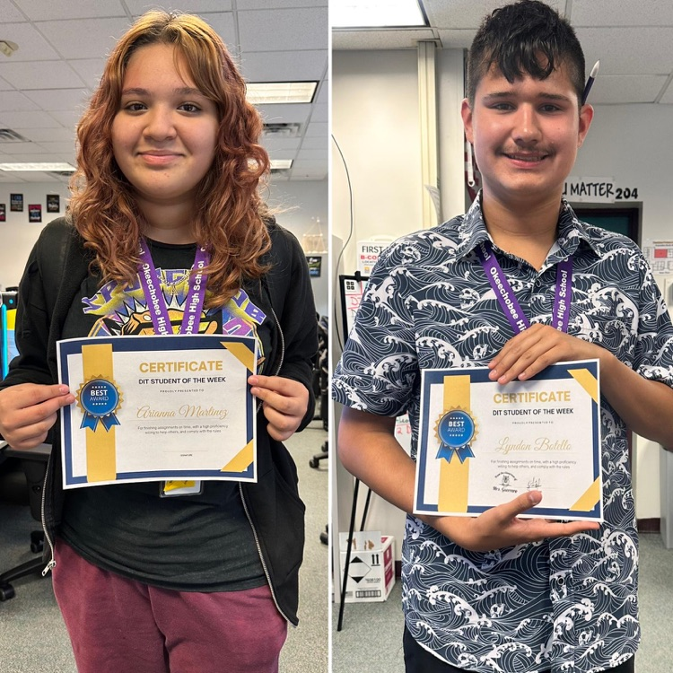 two students holding DIT student of the week certificates 
