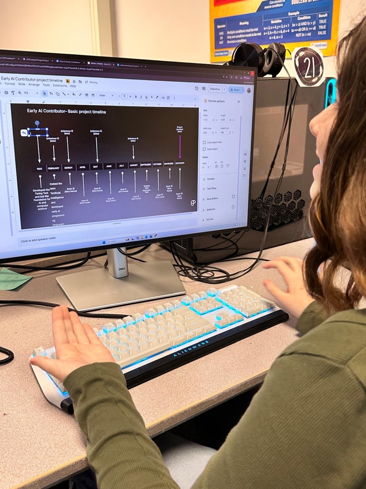 student looking at computer smiling