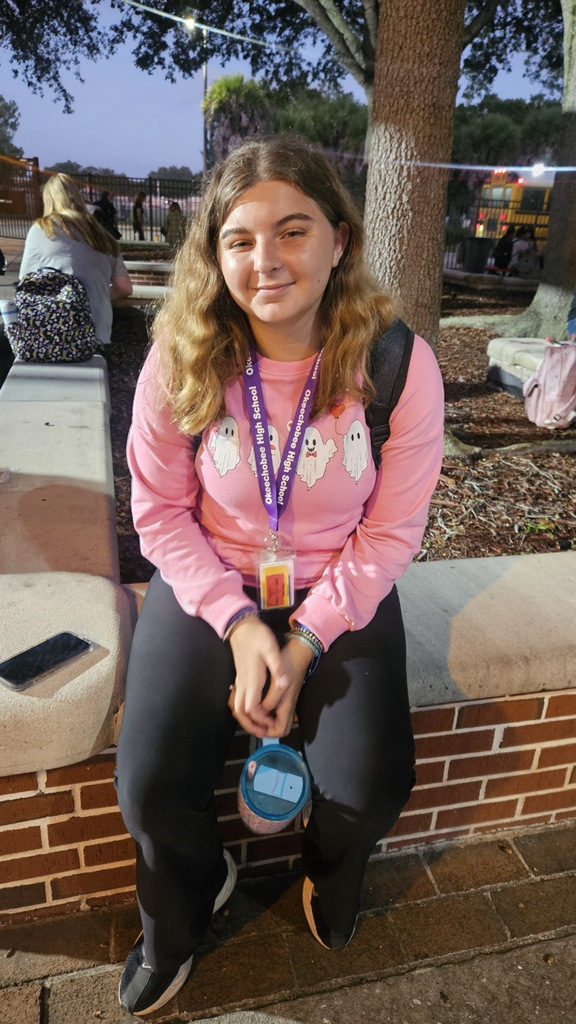 female student wearing pink in courtyard