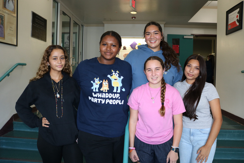 five students in governing board Infront of main office of school