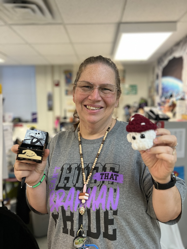 teacher showing off two gifts